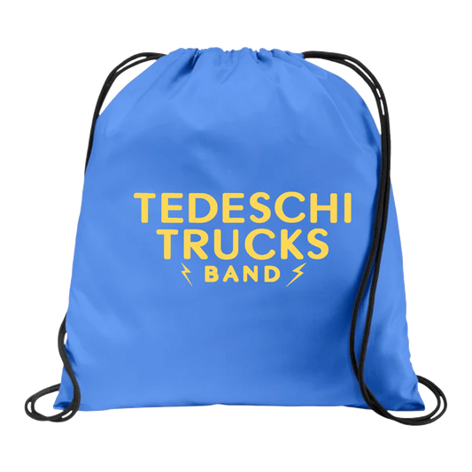 Tedeschi Trucks Band logo in gold on a light blue synch backpack